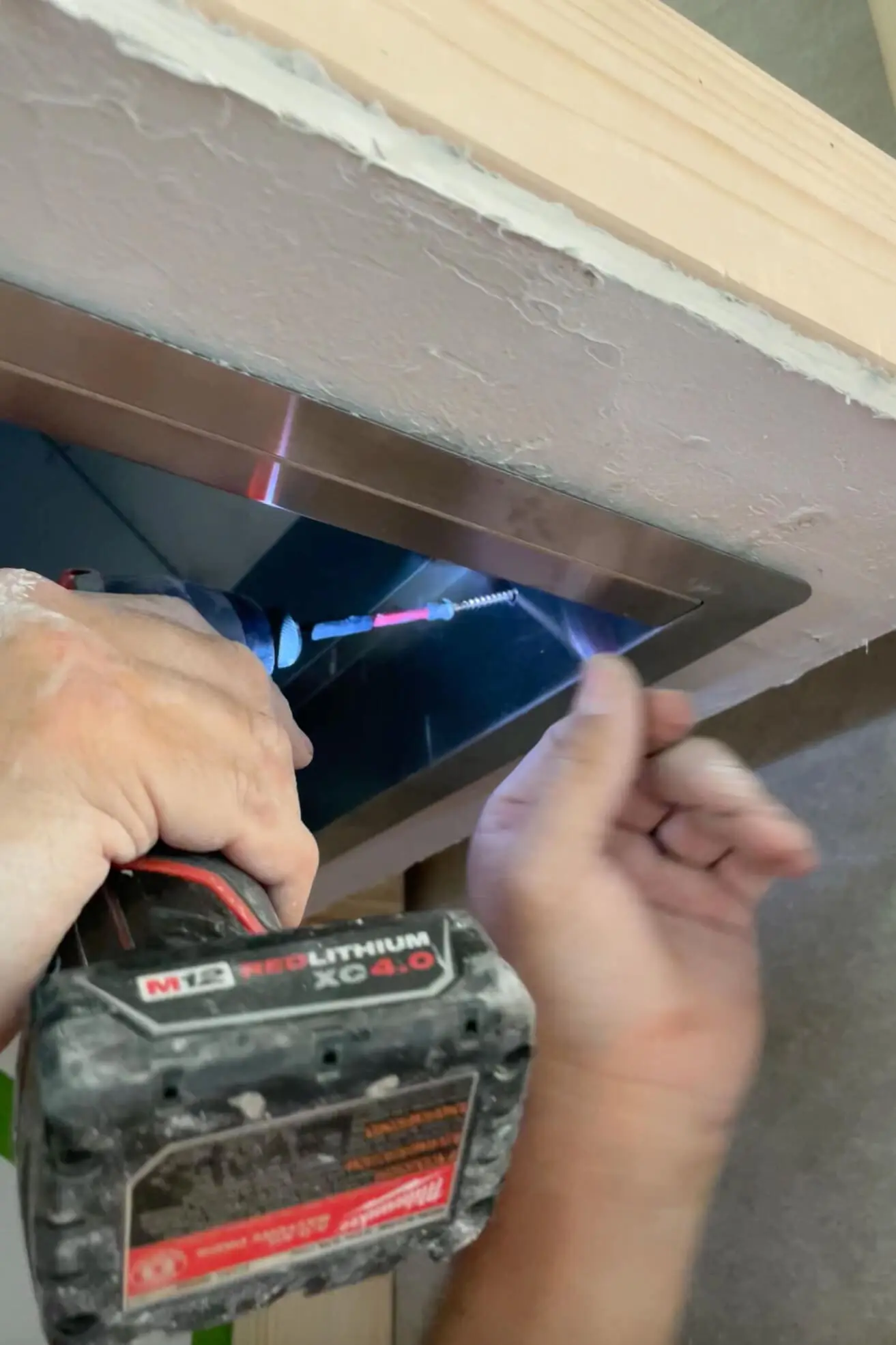 Installing a vent hood insert.